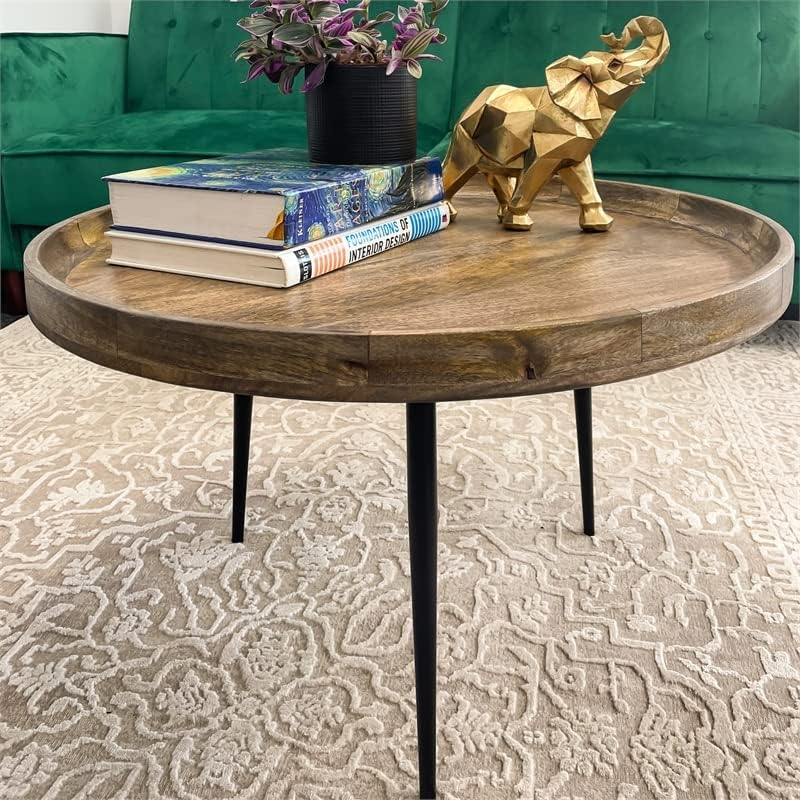 Mango wood coffee table with bowl-shaped top, styled in room setting