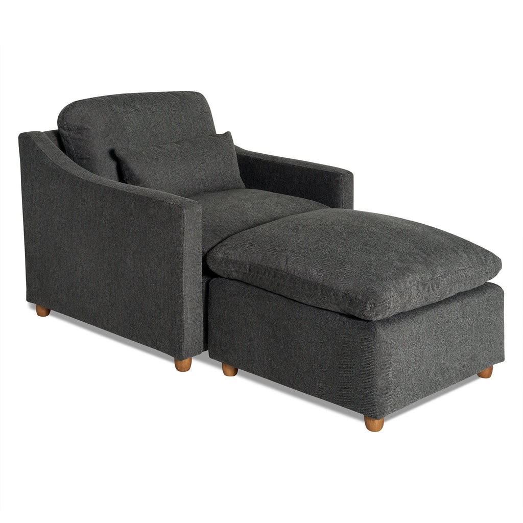 The My Cloud Slope Chair, in dark gray, includes a matching ottoman and wooden legs. With sloped armrests and a cushioned backrest, this set offers modern comfort like sitting on My Cloud.