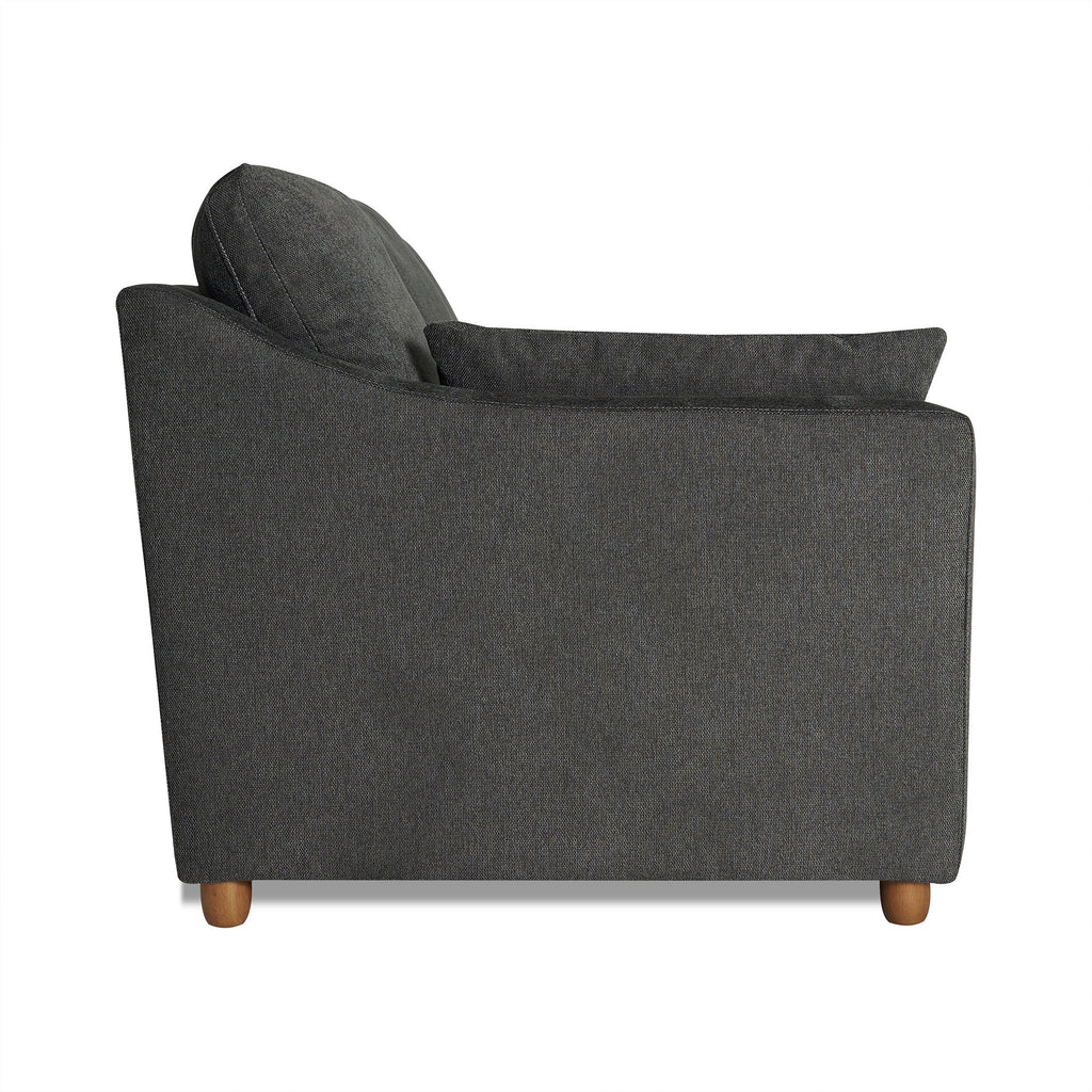 A side view of the My Cloud Slope Loveseat in dark gray reveals a cushioned backrest and armrests, supported by small wooden legs. The soft, textured fabric is perfect for modern or contemporary living rooms looking for customizable furniture solutions.