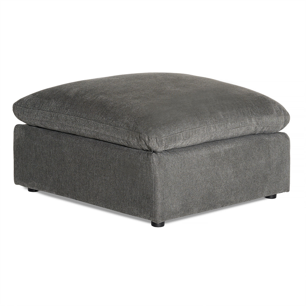 The My Cloud Slope 40 Ottoman features a square, modern design with dark gray fabric and low black feet, offering comfortable elegance. The plush top cushion, matching the base in color and texture, adds a serene touch to any space.