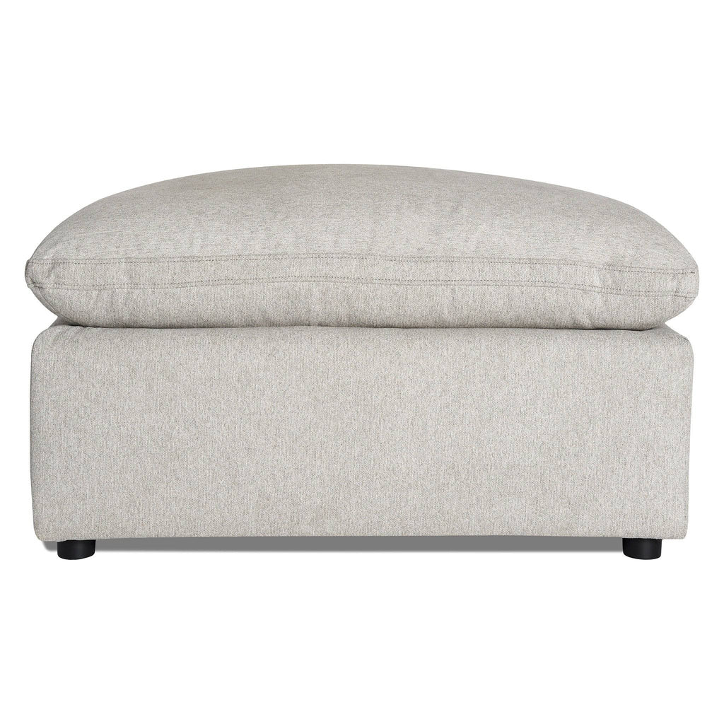 Meet the My Cloud 40 Ottoman, a comfy furniture piece in light gray with a plush cushioned top and minimalist black legs. Its soft, textured fabric enhances its modern and cozy look—perfect for any living space.