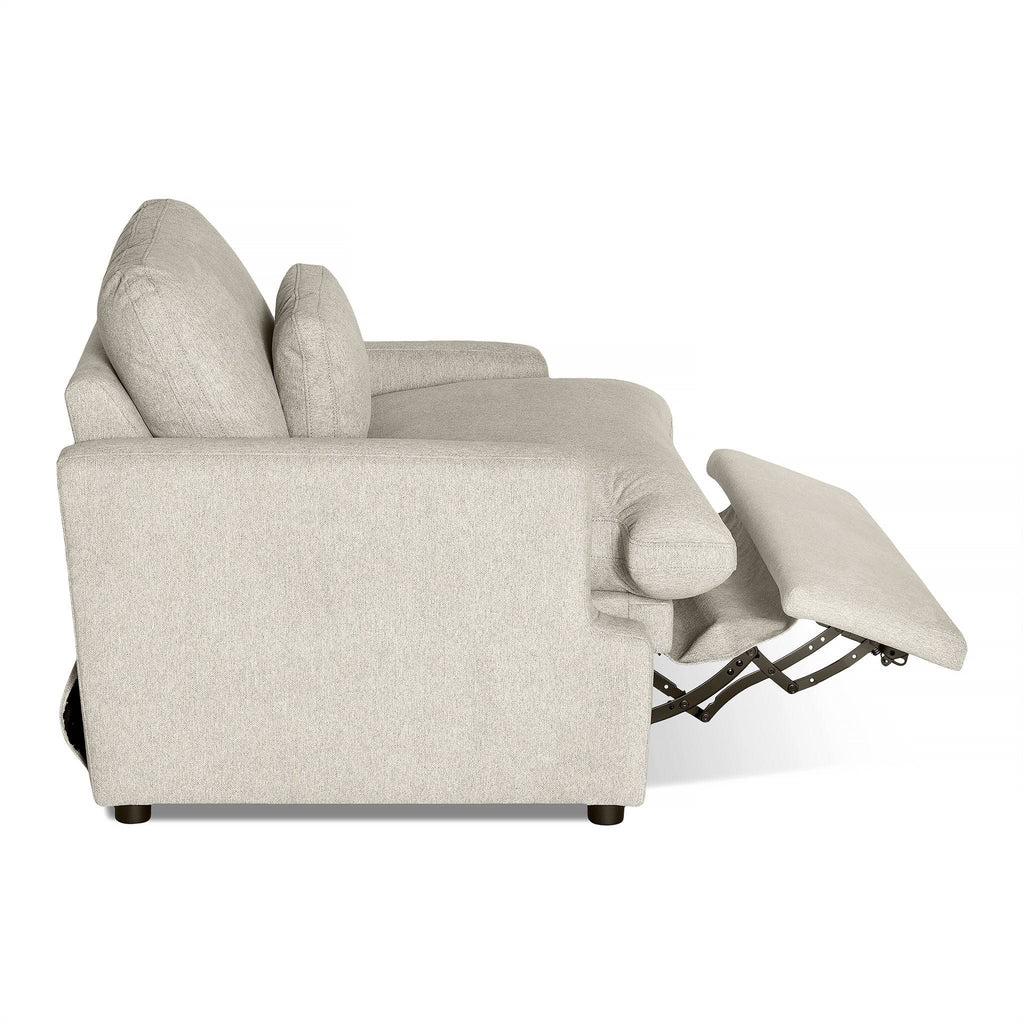 Side view of the My Cloud Power Recliner shows its smooth light gray upholstery, extended footrest, and thick cushions on the seat and backrest. Its slightly curved armrests enhance relaxation.