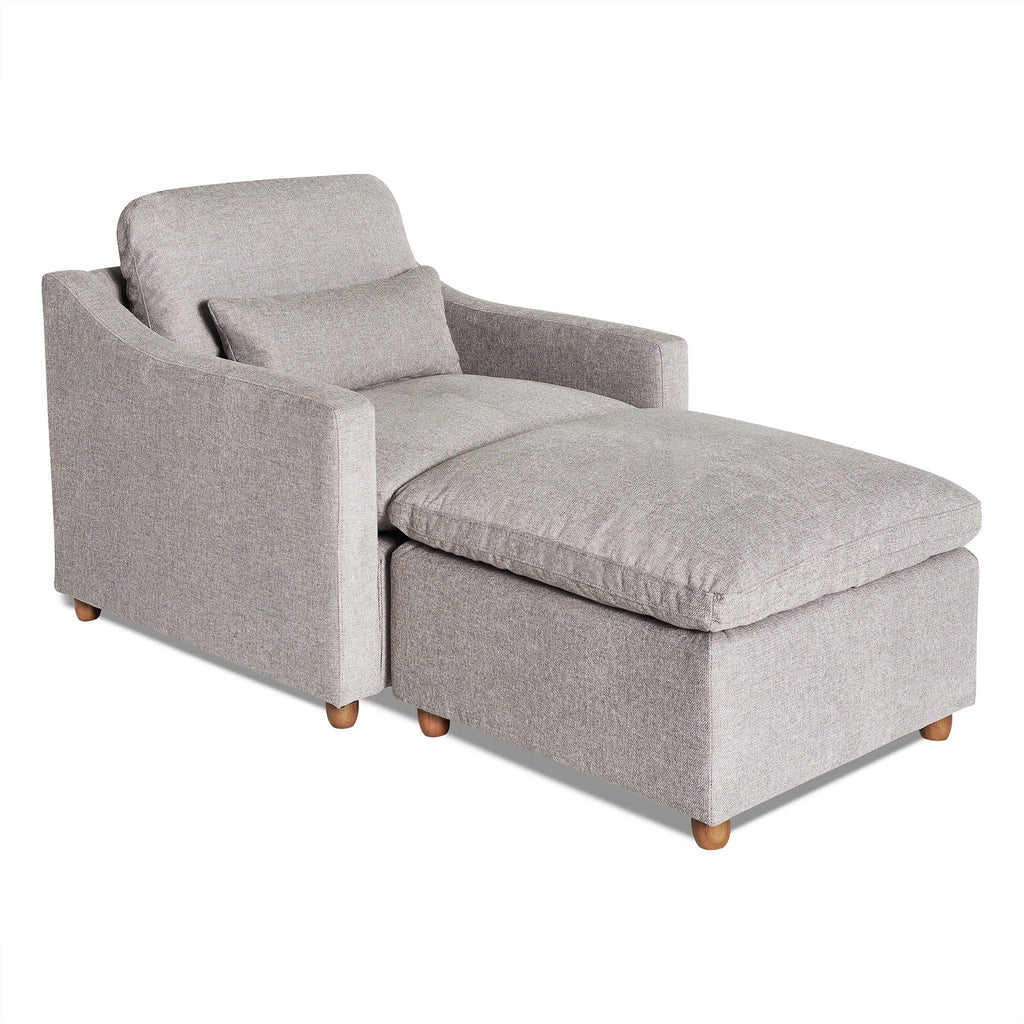 The My Cloud Slope Chair, in light gray, features a padded backrest and seat cushion, slightly curved armrests, wooden legs, and a matching rectangular cushion on the backrest for enhanced comfort.