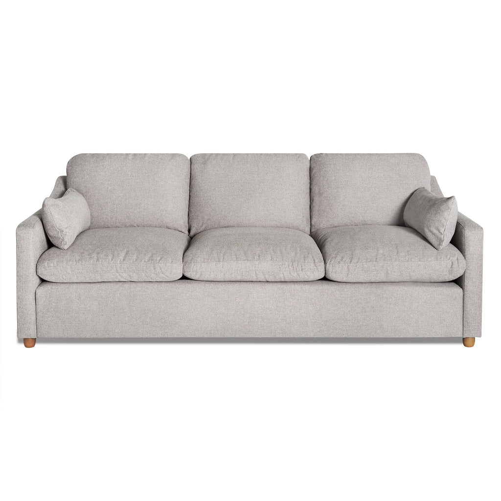 The My Cloud Slope Sofa is a sophisticated light gray three-seater with three seat and back cushions, square armrests, and two matching accent pillows. It sits gracefully on wooden legs, with machine-washable covers ensuring easy maintenance for this customizable piece of furniture.