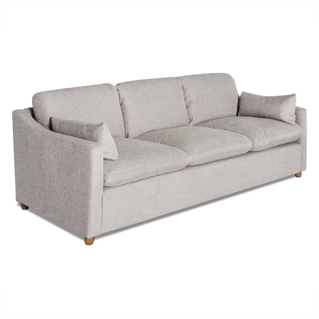 Introducing the My Cloud Slope Sofa: a light gray, three-seater with plush back cushions and two side pillows. Its minimalist design features straight arms and wooden legs. Machine-washable covers make maintenance easy, enhancing its contemporary appeal.