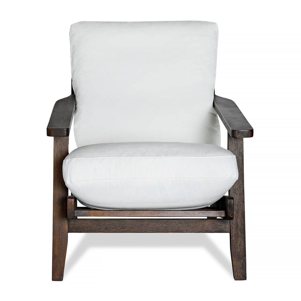 The Peyton Chair features a dark brown wooden frame, thick white cushions for the seat and backrest, and a mid-century style with clean lines and sturdy design for both style and comfort.