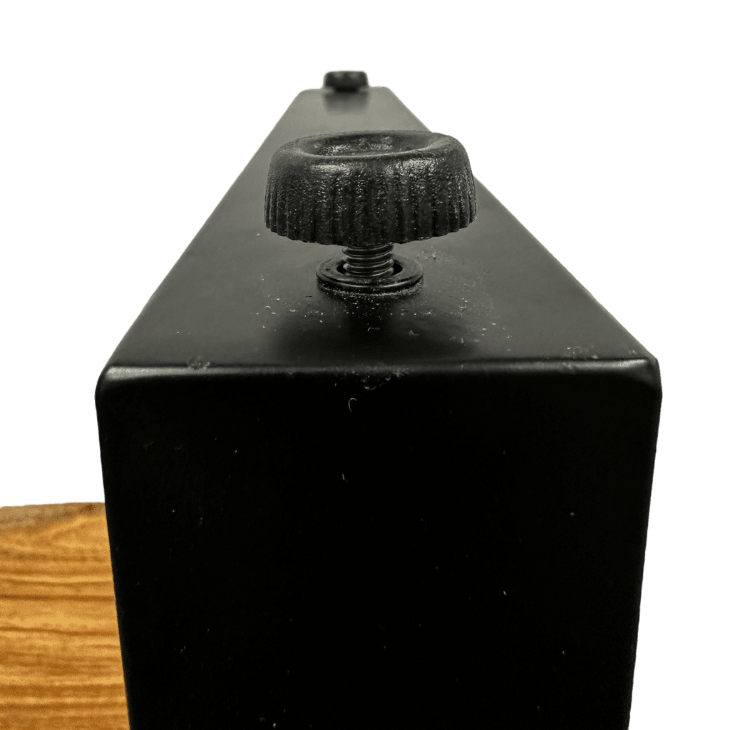 Close-up of a black metal box featuring a textured knob and visible screw, with a small black button in the background. At the bottom, part of the Live Edge End Tables natural wood surface adds rustic charm.