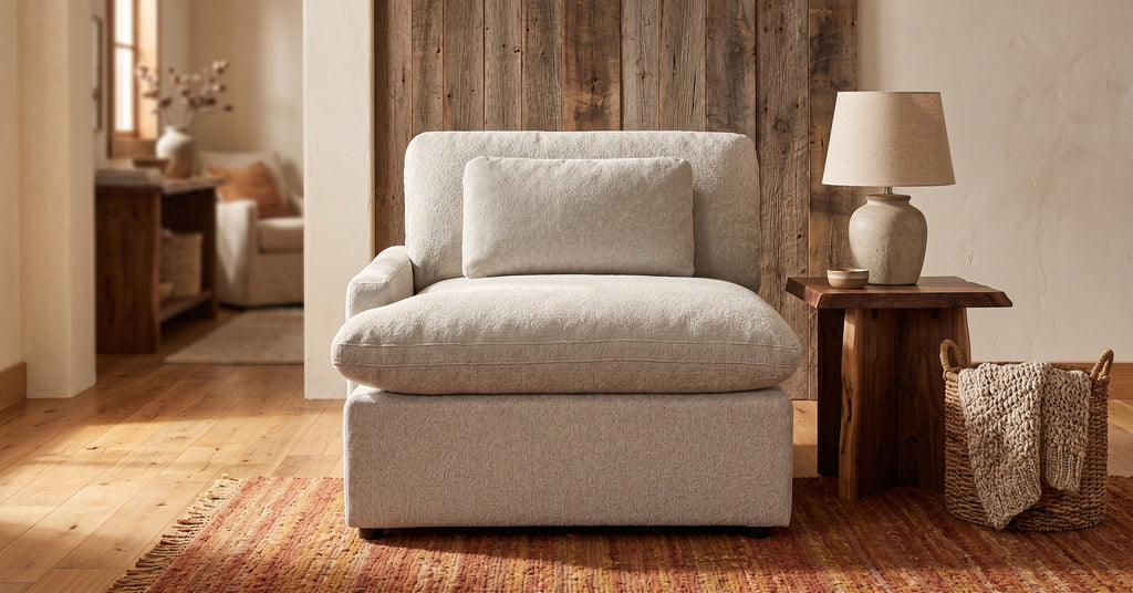 My Cloud Left Arm modular seat in greige boucle staged in a warm rustic living room with a barnwood wall and honey-oak floors