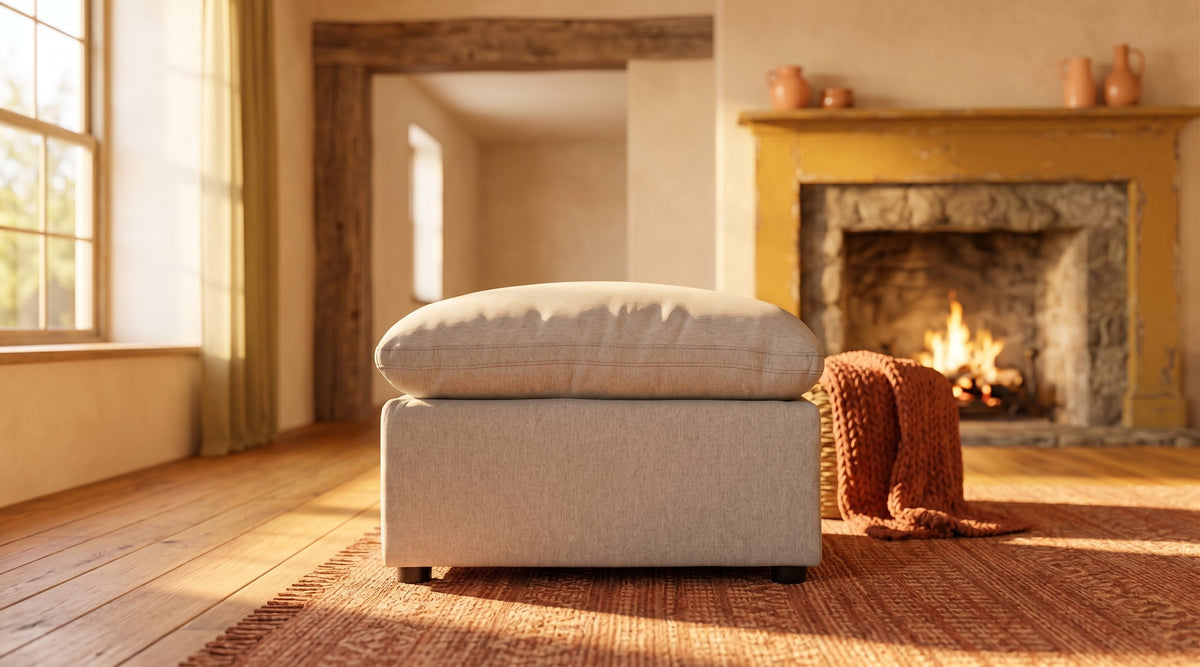 My Cloud 30 inch Ottoman in greige, styled by a stone fireplace in a warm rustic living room