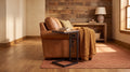 Live edge USB C-table with built-in outlet sliding under a caramel leather chair in a warm rustic living room