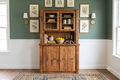 Barnwood buffet and hutch styled against a sage-green wall