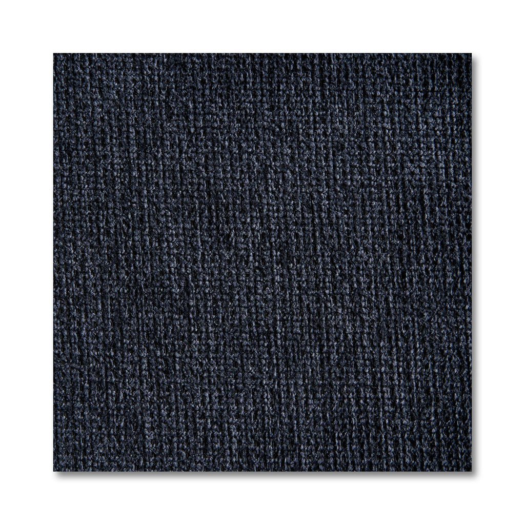 Close-up of a dark blue textured carpet tile with vertical ribbed patterns, reminiscent of the design in My Cloud 4 Piece Straight. The square tile, resembling machine-washable fabric sections, stands out against a white background, highlighting its detailed fibers.