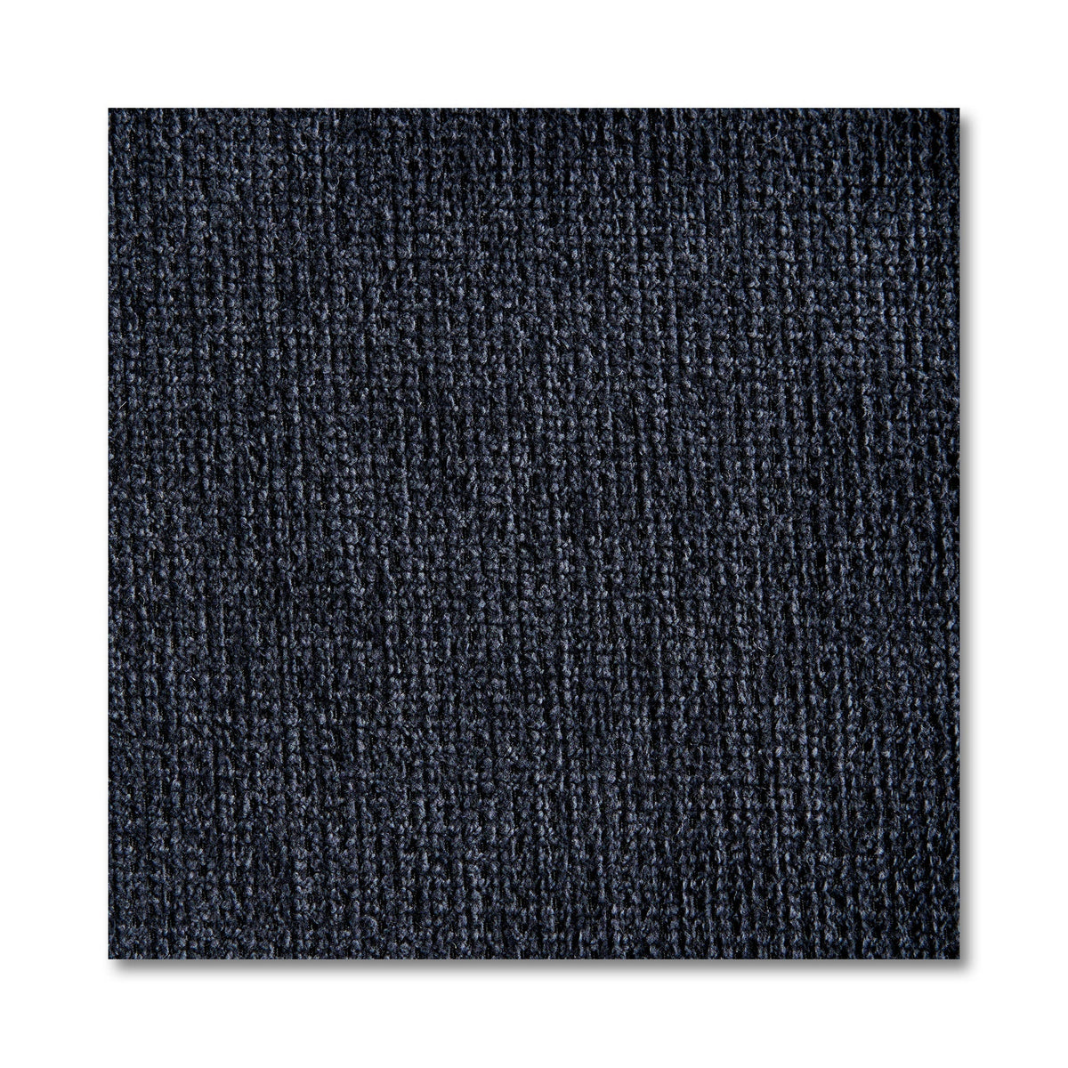 Close-up of a dark blue textured carpet tile with vertical ribbed patterns, reminiscent of the design in My Cloud 4 Piece Straight. The square tile, resembling machine-washable fabric sections, stands out against a white background, highlighting its detailed fibers.