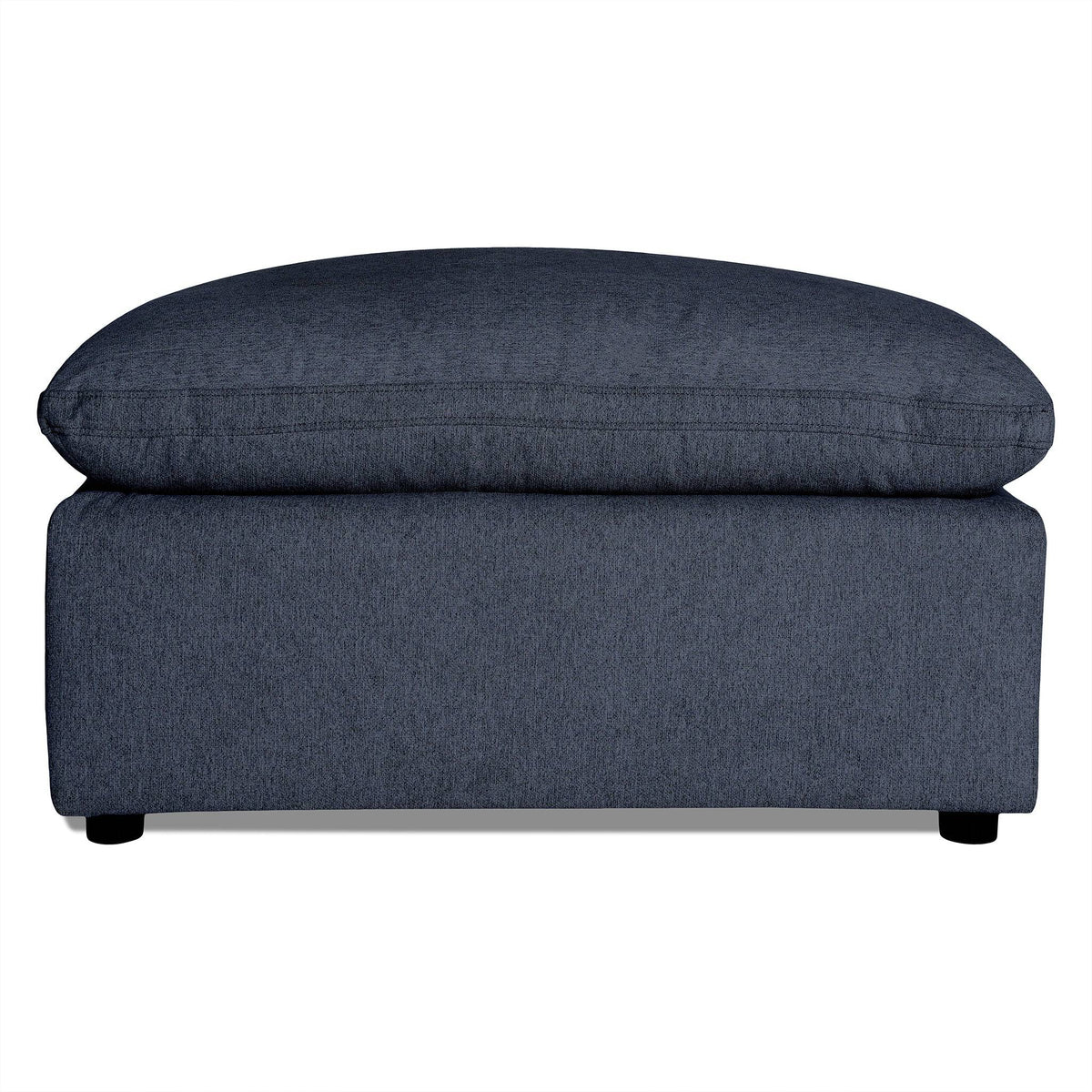 The My Cloud 40 Ottoman features dark gray upholstery with a soft cushioned top and short black legs. Its textured fabric adds to the modern, minimalist design, making it an ideal customizable piece for any living room.