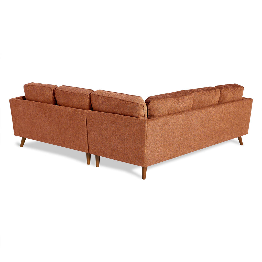 The Maddox sectional sofa is ideal for any living room, featuring a modern mid-century design with clean lines, rust-colored upholstery, and wooden legs. Its minimalist look includes multiple cushions resting against a simple white backdrop.