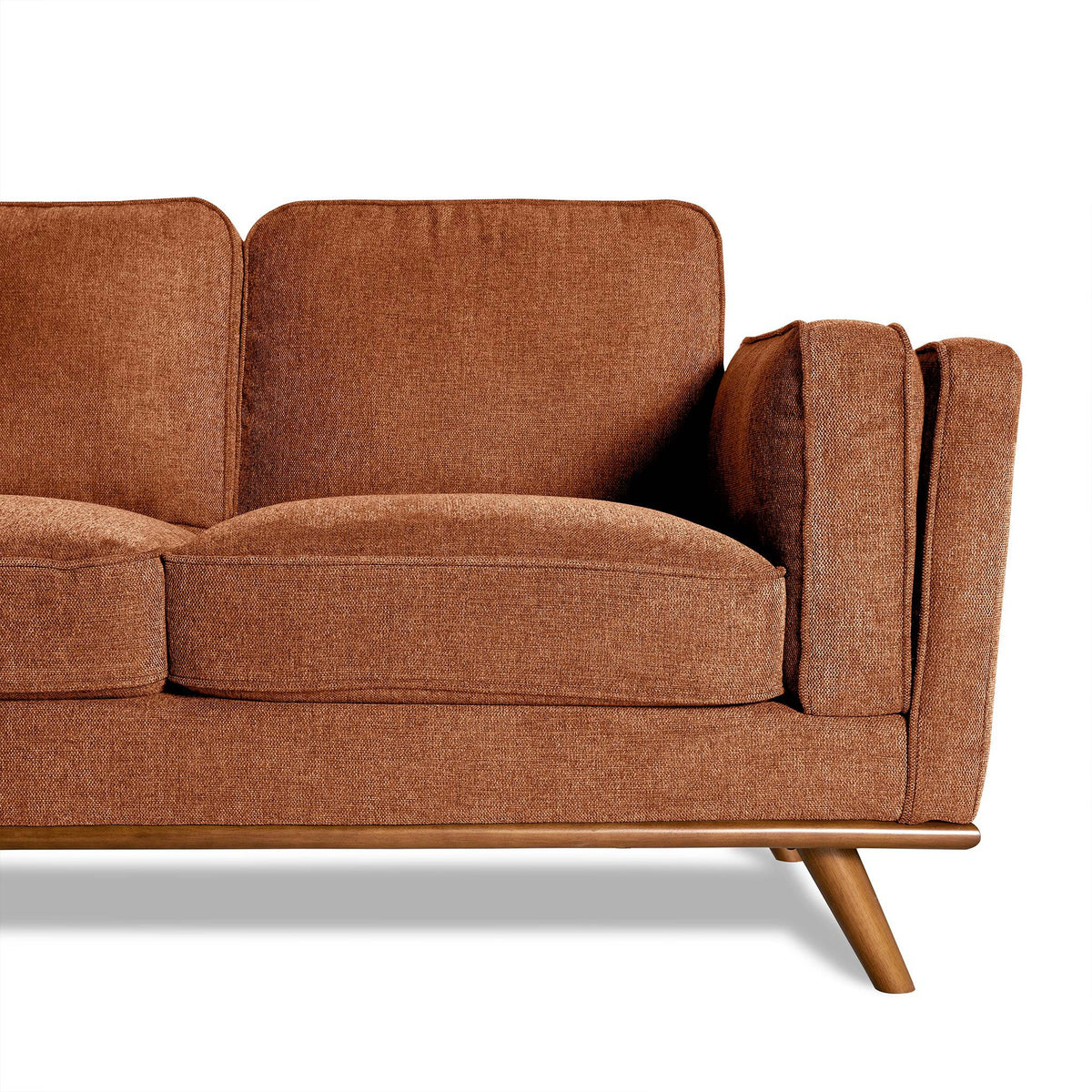 The Maddox Sectional, with its mid-century modern style, features brown upholstery, cushioned seats, angled wooden legs, and a right-side armrest. These elements elevate any living room space. The image highlights the elegant sofas right half.