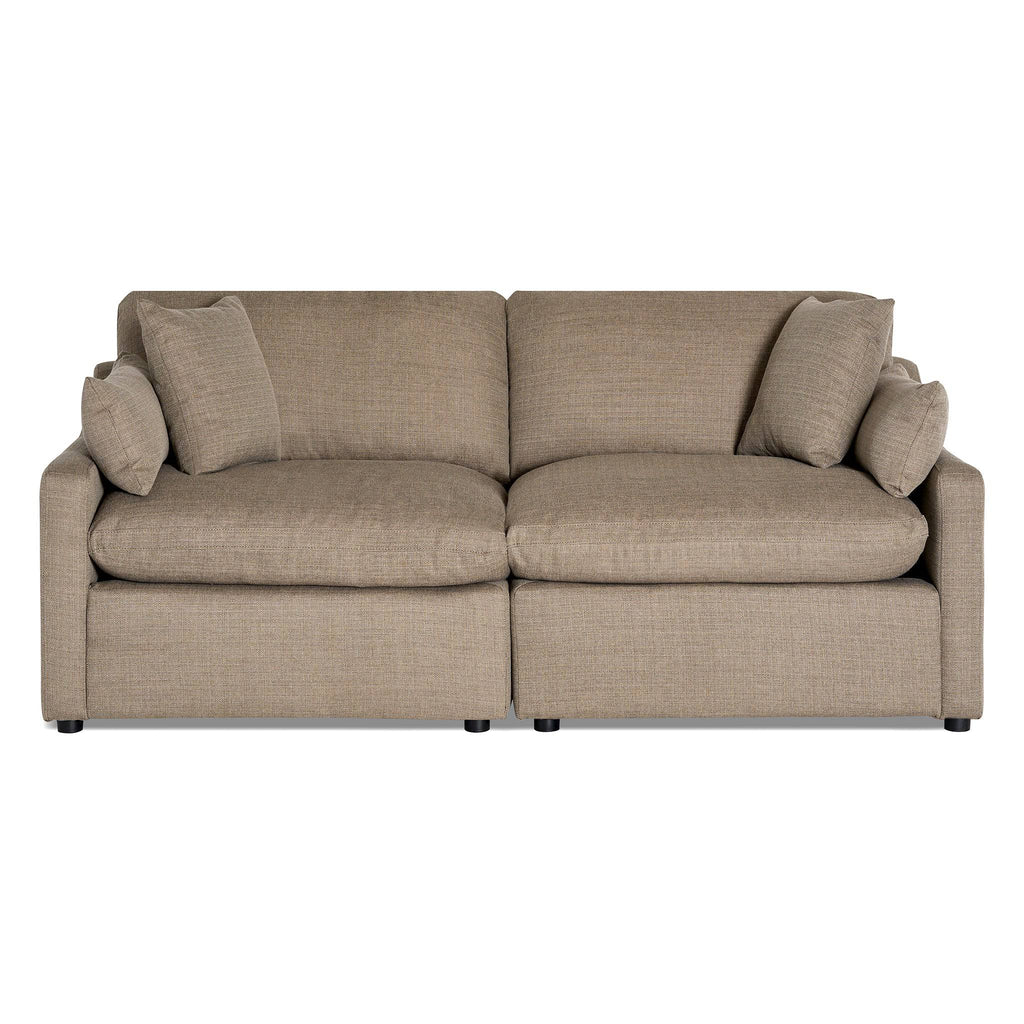 The My Cloud / Slope Arm is a tan, two-seater sofa with puffy cushions and rectangular armrests. It features machine-washable covers and comes with two matching throw pillows on each side, all set against a plain white background.