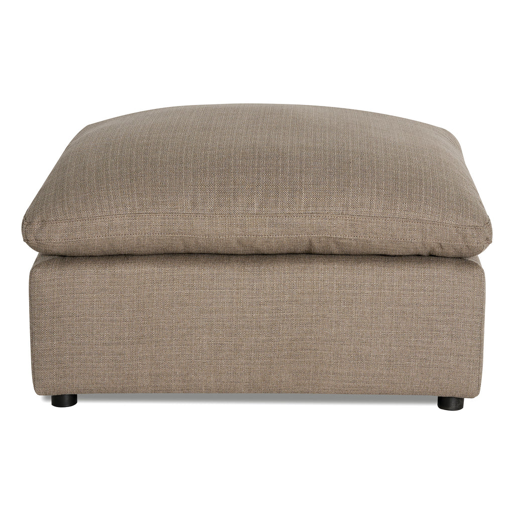 The My Cloud Slope Armless is a beige fabric ottoman with a cushioned rectangular top. Featuring a modern design and short black legs, its perfect as part of a sectional sofa, serving as both a footrest and extra seating.