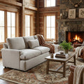 My Cloud Sofa in Greige staged in a rustic lodge living room with warm wood tones