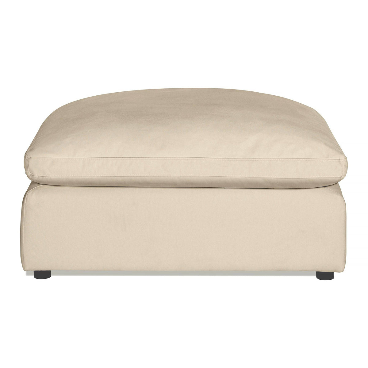 The Peyton Ottoman showcases a minimalist modern style with its beige, rectangular cushion top and simple design. Supported by small dark legs, it provides extra comfort with plush cushioning, making it perfect for any living room or lounge.