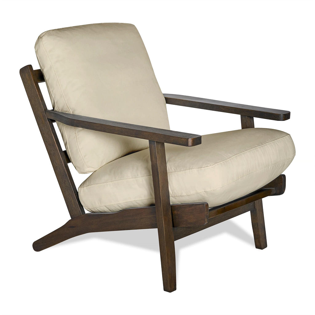 The Peyton Chair is a mid-century style wooden armchair with a dark brown frame and light beige cushions. It features angled legs and simple armrests, offering a modern, minimalist design ideal for any space.