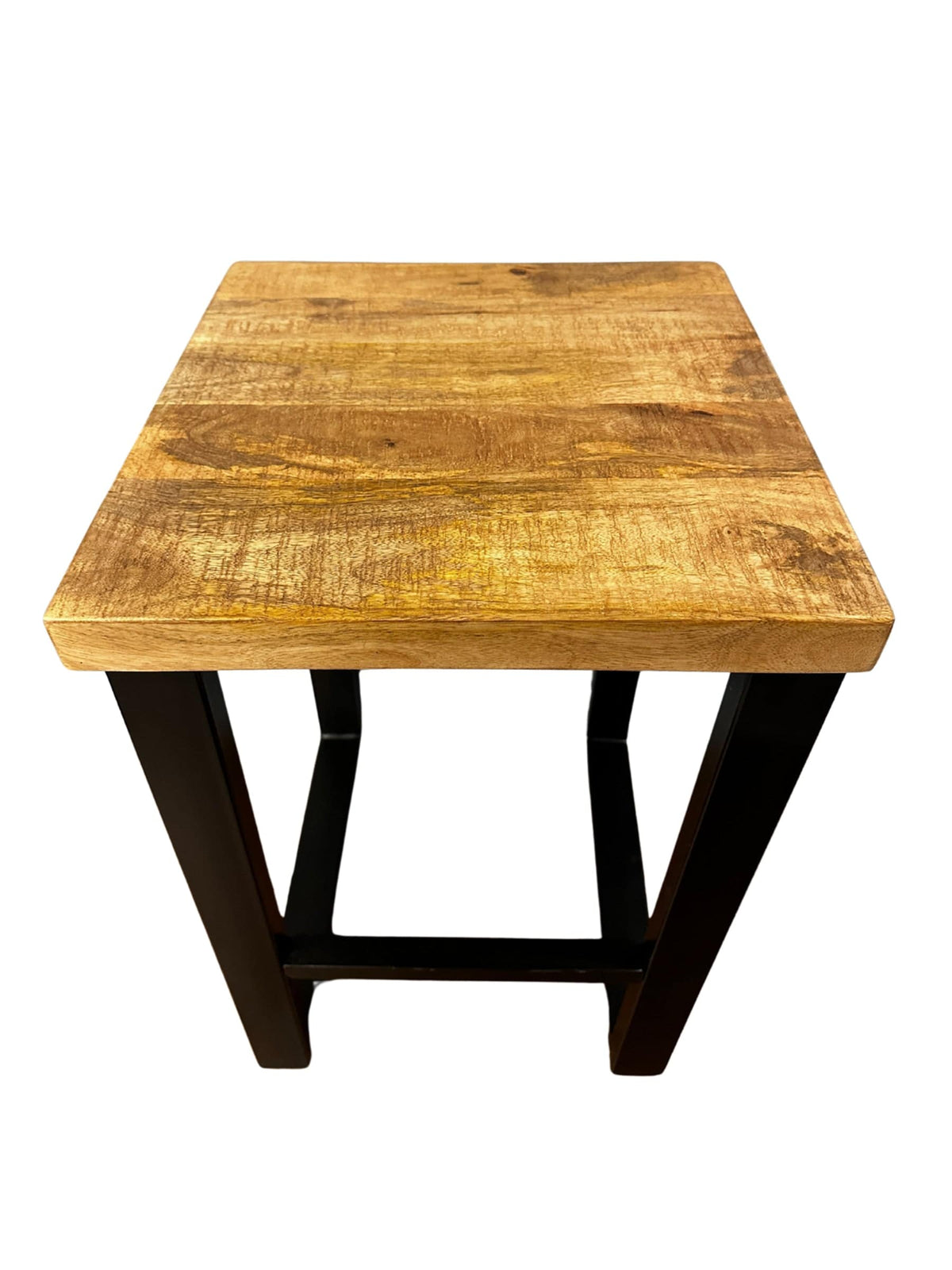 The Mango Stool, made from sustainable mango wood, features a square top and elegant black metal legs. Its natural finish reveals beautiful grain patterns when viewed from above, making it an ideal accent piece for any room.